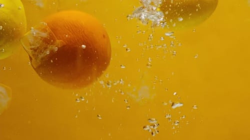 Fresh Citrus Fruits Splashing into Water