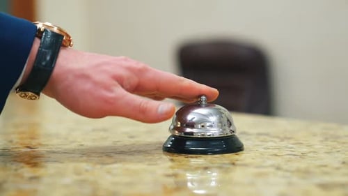 Service bell locating at reception. Customer ringing hotel reception service bell