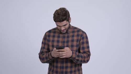 Man Using Smartphone and Thinking