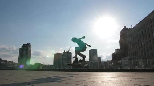 Skateboarder Does Tricks on Sunny Urban Day
