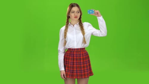 Schoolgirl Shows Her Thumb Down. Green Screen