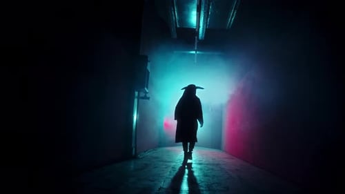Mysterious Figure Walks Dark Urban Hallway at Night