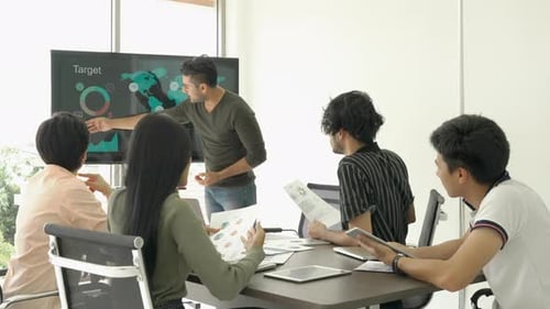 Business Meeting with Data Presentation in Office