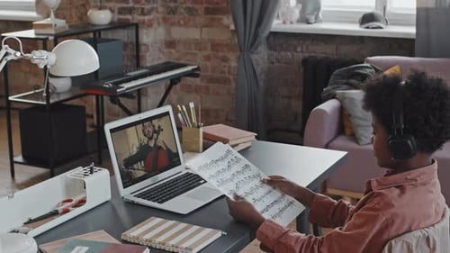 Child Learning Music with Online Cello Lesson