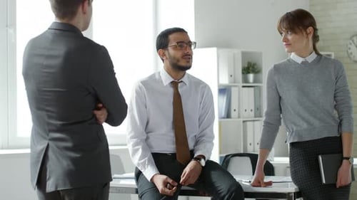 Multiethnic Coworkers Discussing Job in Office
