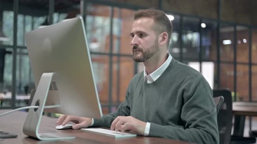 Young Man Working on Computer and Left the Desk