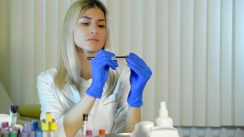 Woman Scientist Examining Blood Sample in Lab