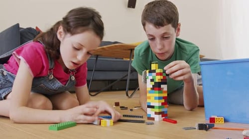 Children Play Together Building Colorful Block Tower