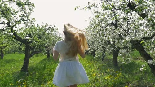 Girl running in an orchard