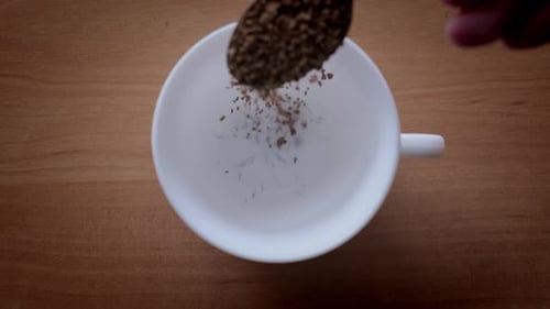 Instant Coffee Spooned Into Clean White Mug