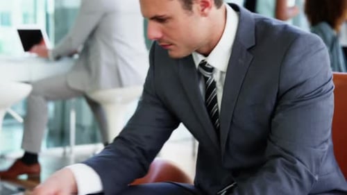 Man in Suit Working at Laptop in Modern Office