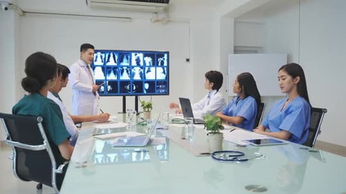 Medical Team Discussing X-Rays in Conference Room