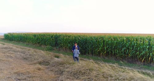 Two Farmers Working on Agriculture Field