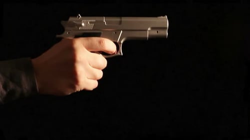 Hand Holding Silver Handgun Against Black Background
