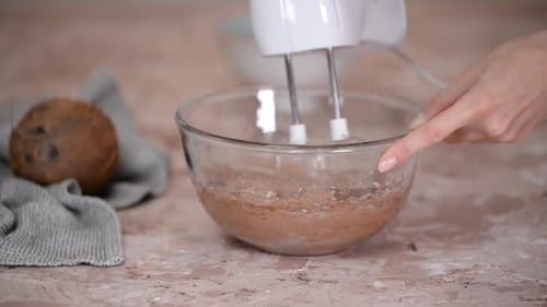 Electric Mixer Blends Batter in Glass Bowl