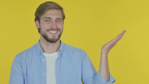 Young Adult Man Presenting an Imaginary Product