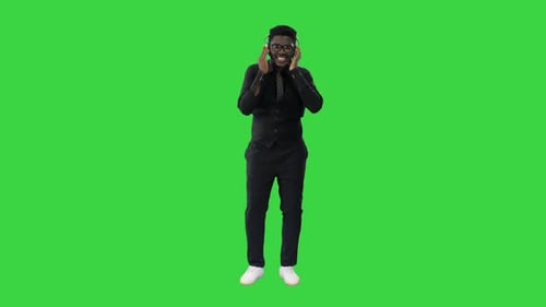 Man Listening to Music with Headphones on Green Screen
