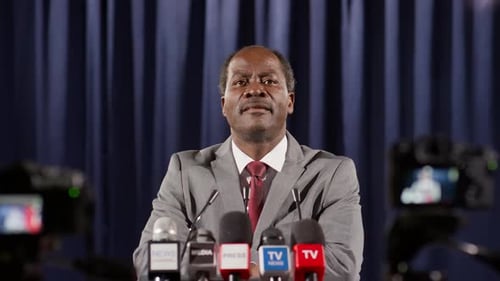 Man Giving Press Conference in Suit