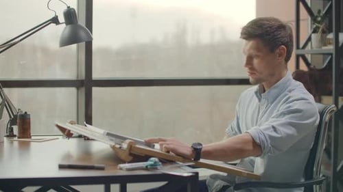 Architect Working at Drafting Table in Office