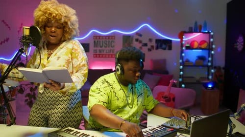 Female Singer Recording Song with Sound Engineer