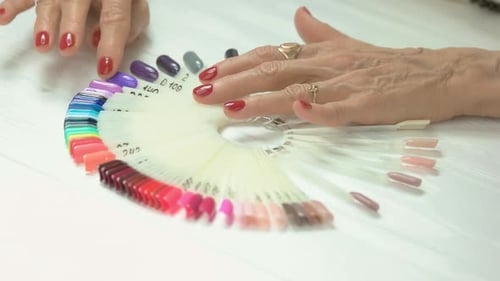 Mature Adult Choosing Nail Polish Color