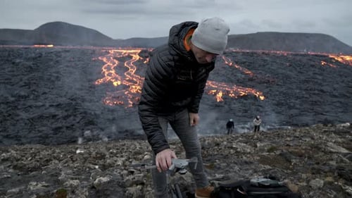 Man Prepares Drone in front of Lava Landscape