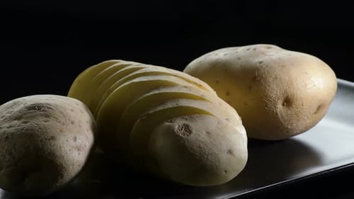 Potato Cut Gyrating on a Black Tray