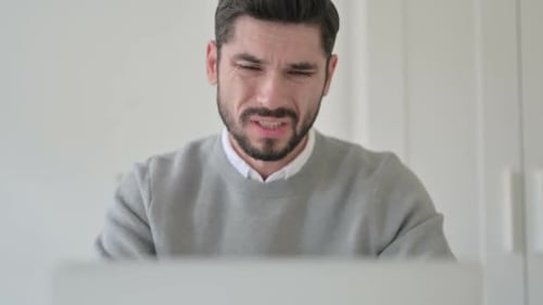 Close Up of Man Having Neck Pain While Using Laptop