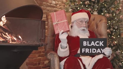 Santa Holding Black Friday Sign and Gift