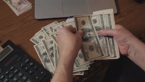 Counting Cash Money on Office Desk