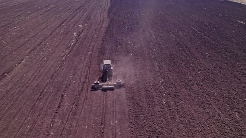 Tractor in the Dust Working in the Field