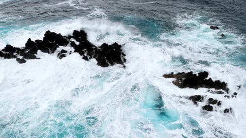 Drone Spin Around Big Waves Crashing Into Cliffs Near the Shores of Madeira Island Portugal