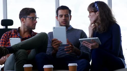 Team Working Together With Tablets in Office