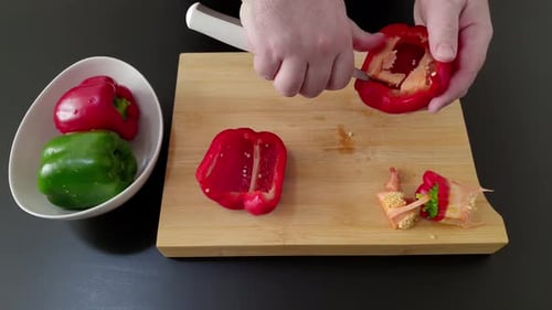 Hands Preparing Red Bell Pepper with a Knife