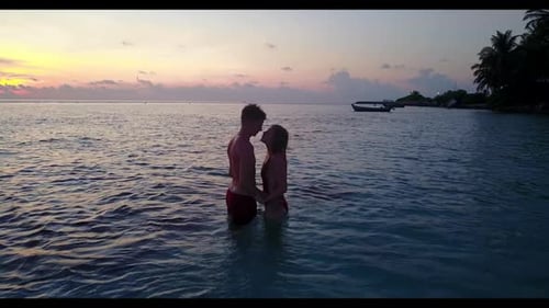 Romantic couple relax on idyllic bay beach voyage by clear ocean with white sandy background of the