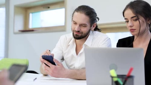 Office. Man Using Phone, Woman Working On Computer At Workplace