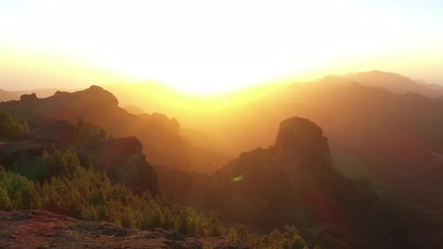 Man on Mountain Top at Golden Sunrise