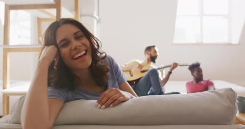 Woman Smiles with Friends Relaxing at Home