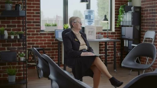 Woman Sits in Group Circle for Meeting in Office