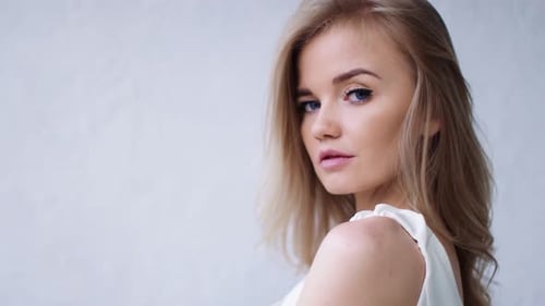 Flirting Adorable Lady with Wave Hairstyle Perfect Skin Pose at White Studio