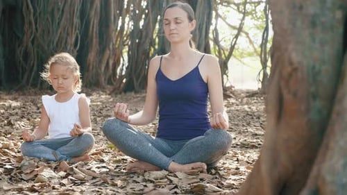 Mother and Child Meditating in Nature