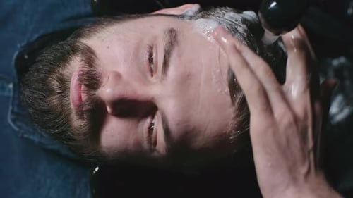 Barber Shampooing Hair of Client