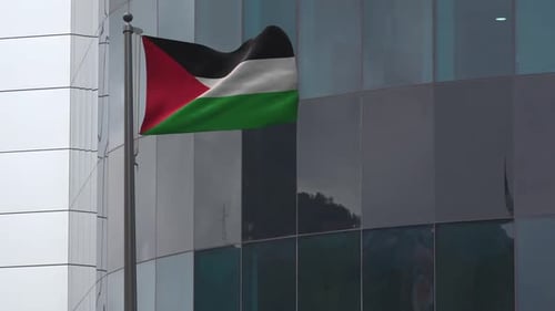 Palestinian Flag Waving on Modern Building Background