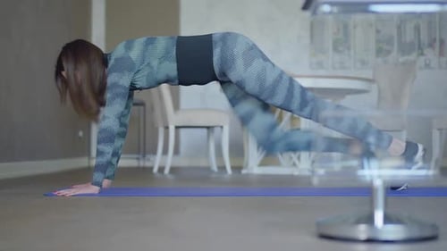 Wide Shot of Young Slender Sportswoman Doing Running Plank Exercise Indoors. Side View of