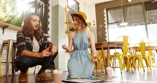 Creative executives discussing a document in cafeteria 4k