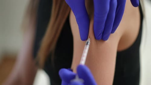 Close Up Syringe Injection in Arm