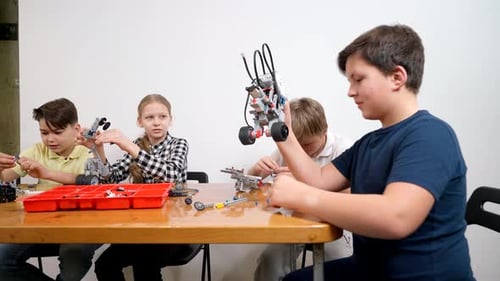 Children Building Robotics Projects in Bright Classroom
