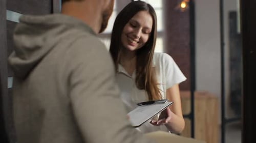 Woman Signing for Home Package Delivery