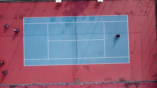 People in wheelchair playing tennis on court. Wheel Chair Tennis For Disabled. Aerial drone footage