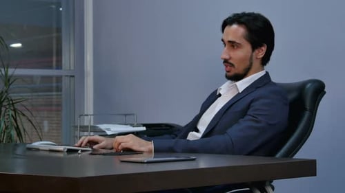 Serious Man Sitting in Office